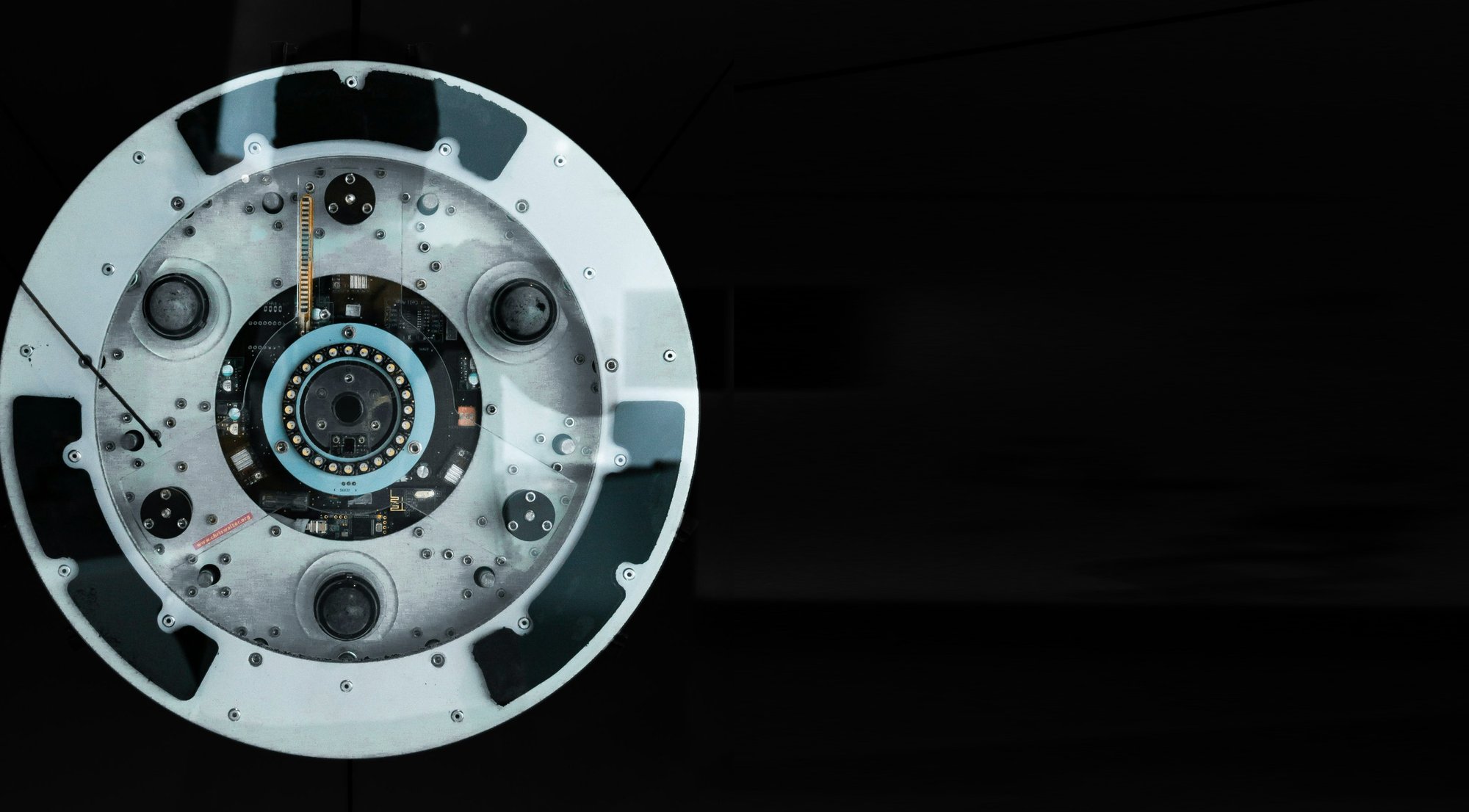 Close-up of a robotics motor and circuit assembly against a dark background