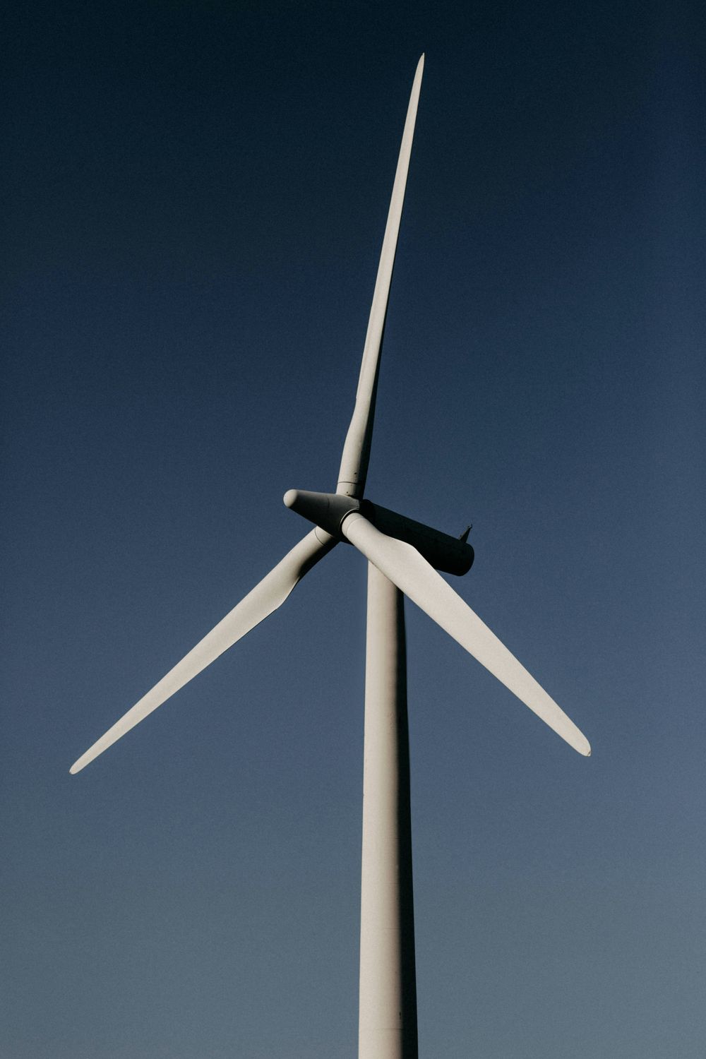 Wind turbine under blue sky